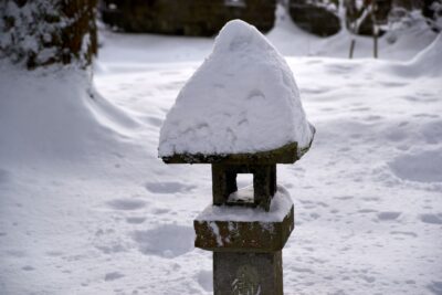 Stone lanterns in the grounds of Oyama Shrine, covered in deep snow