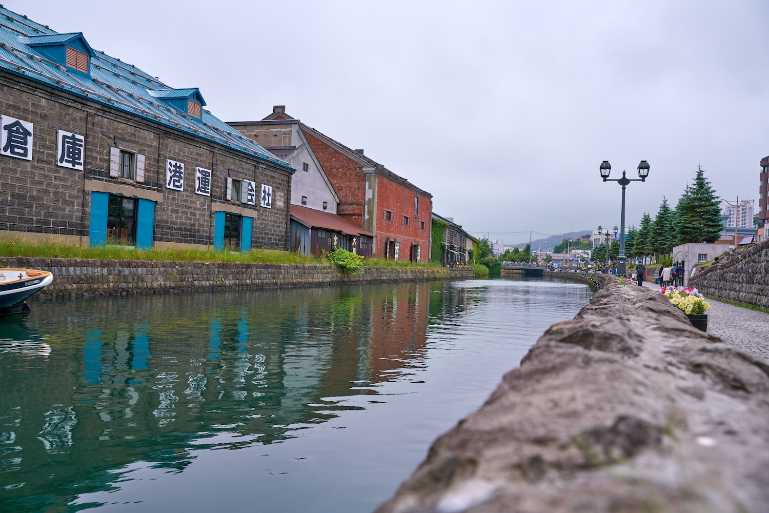The scenery of Otaru Canal lined with stone warehouses and the promenade