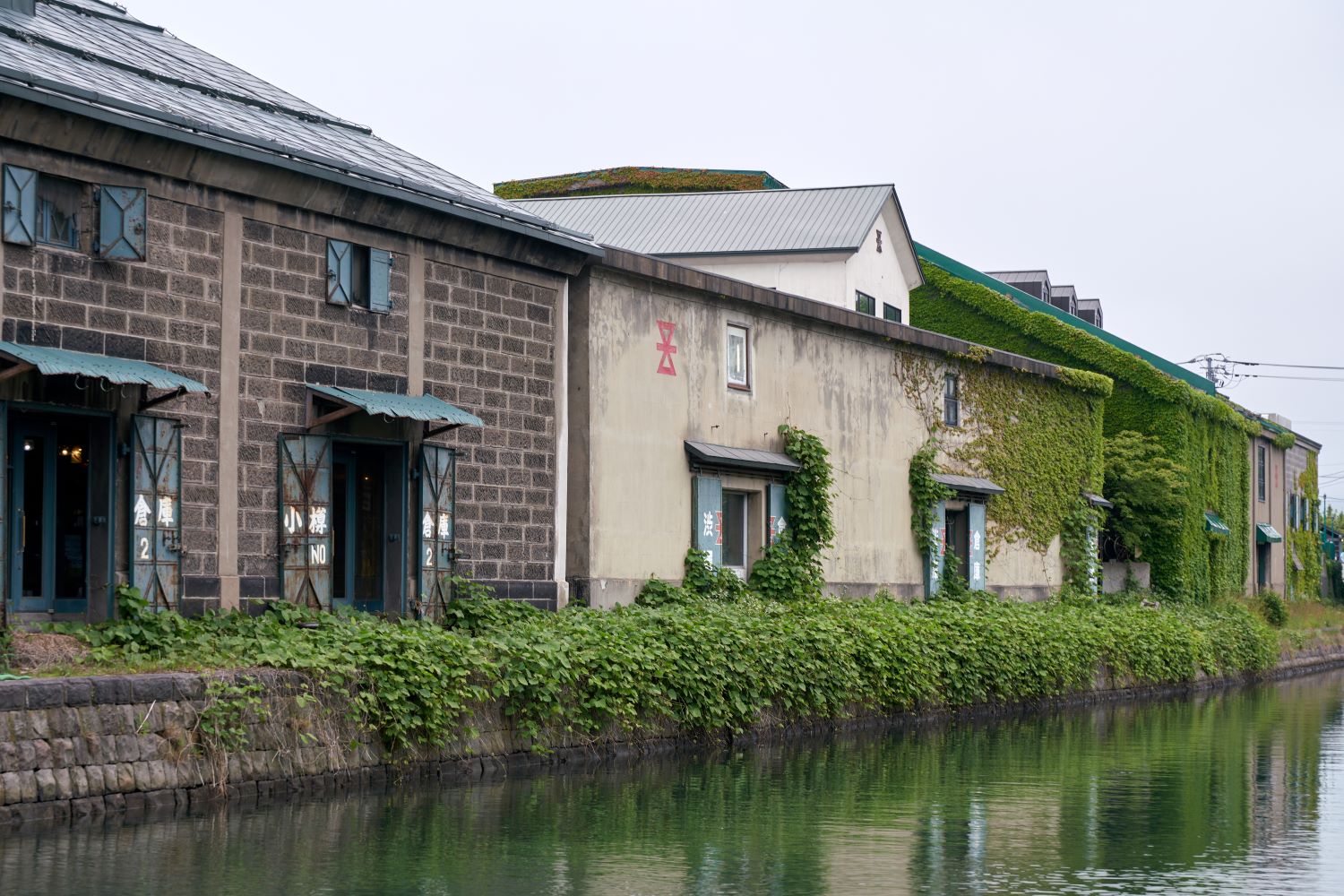 The old warehouse covered in ivy and the tranquil surface of Otaru Canal