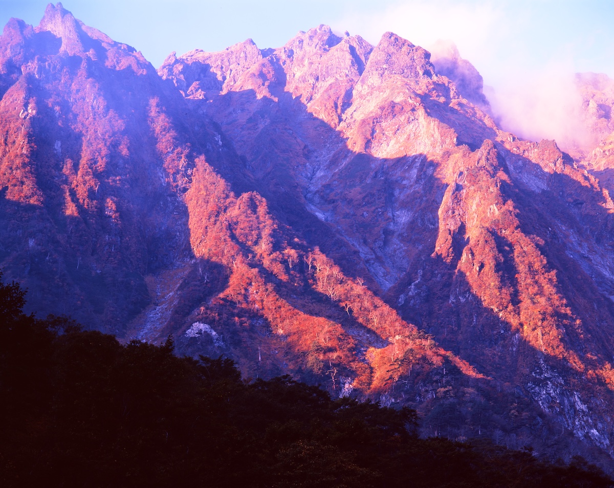 The rock face of Tanigawa-dake's Ichinokurasawa, dyed crimson by the morning sun