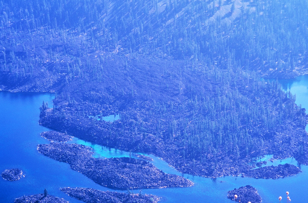 Close-up of Wizard Island floating in the center of Crater Lake, featuring the volcanic dome and forest scenery