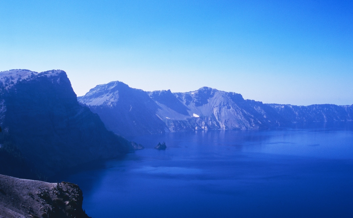 The caldera's cliffs surrounding Crater Lake and the blue lake surface