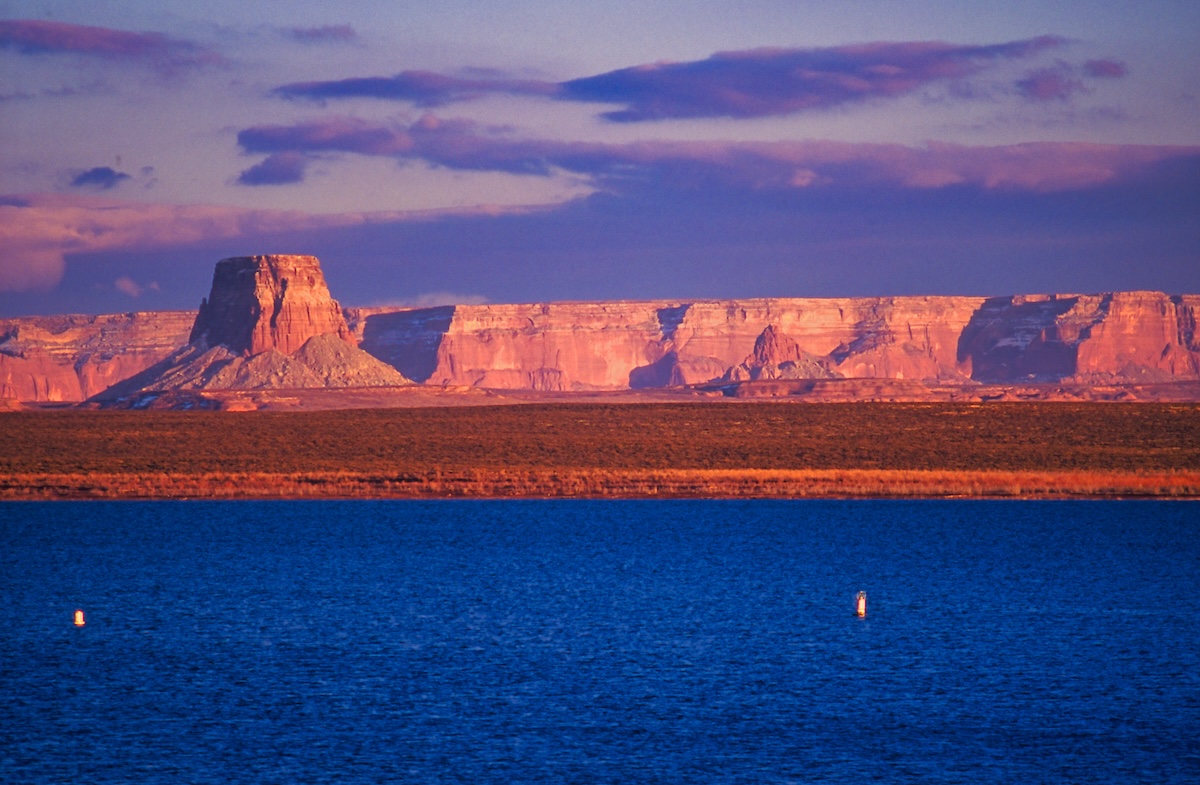 The rock walls of Lake Powell and the orange sky dyed by the sunset