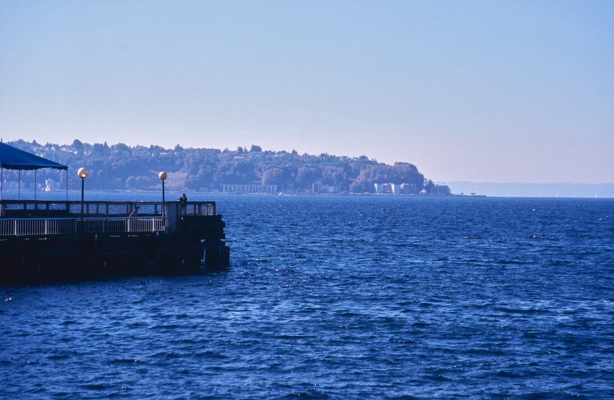 A view of the vast, calm surface of Lake Powell under cloudy skies